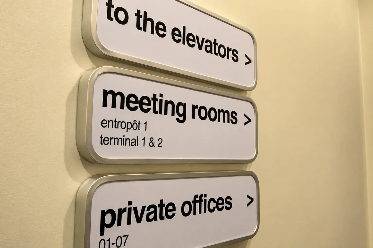 Wall-mounted wayfinding signs for lifts, meeting rooms and offices