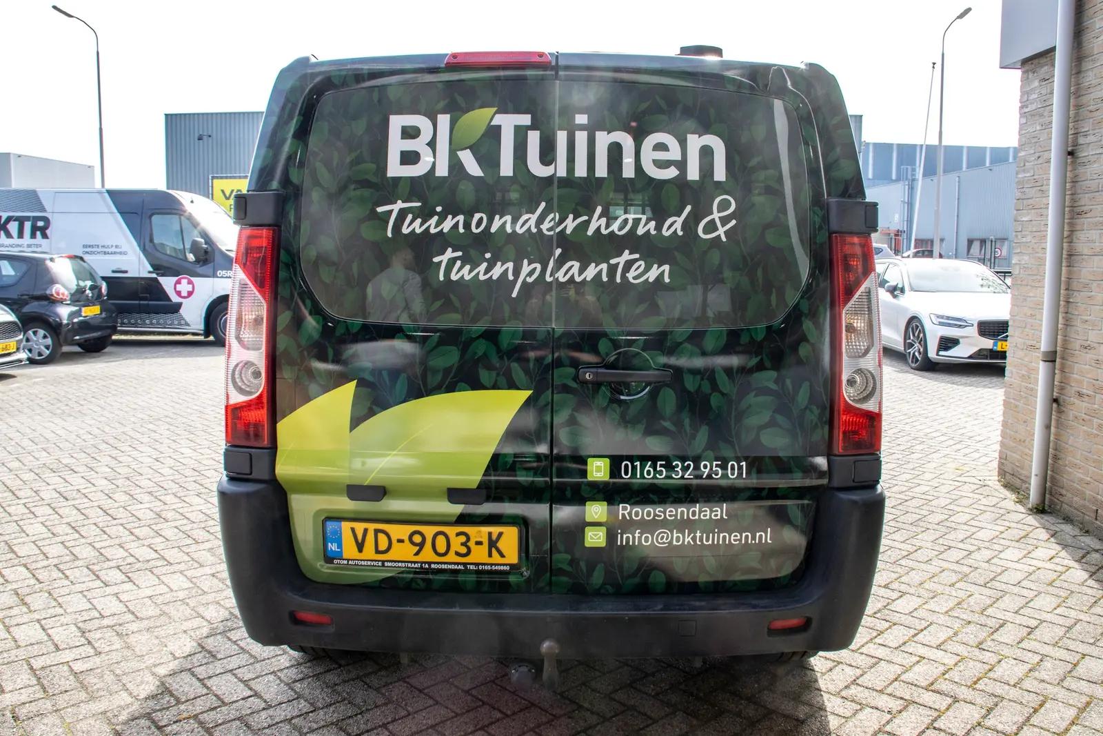 Rear doors with business name and garden graphics