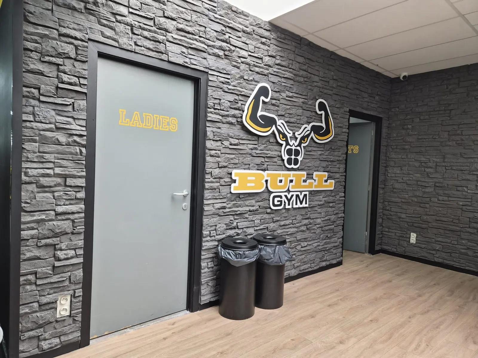 Bull Gym logo and changing-room lettering beside an internal door.