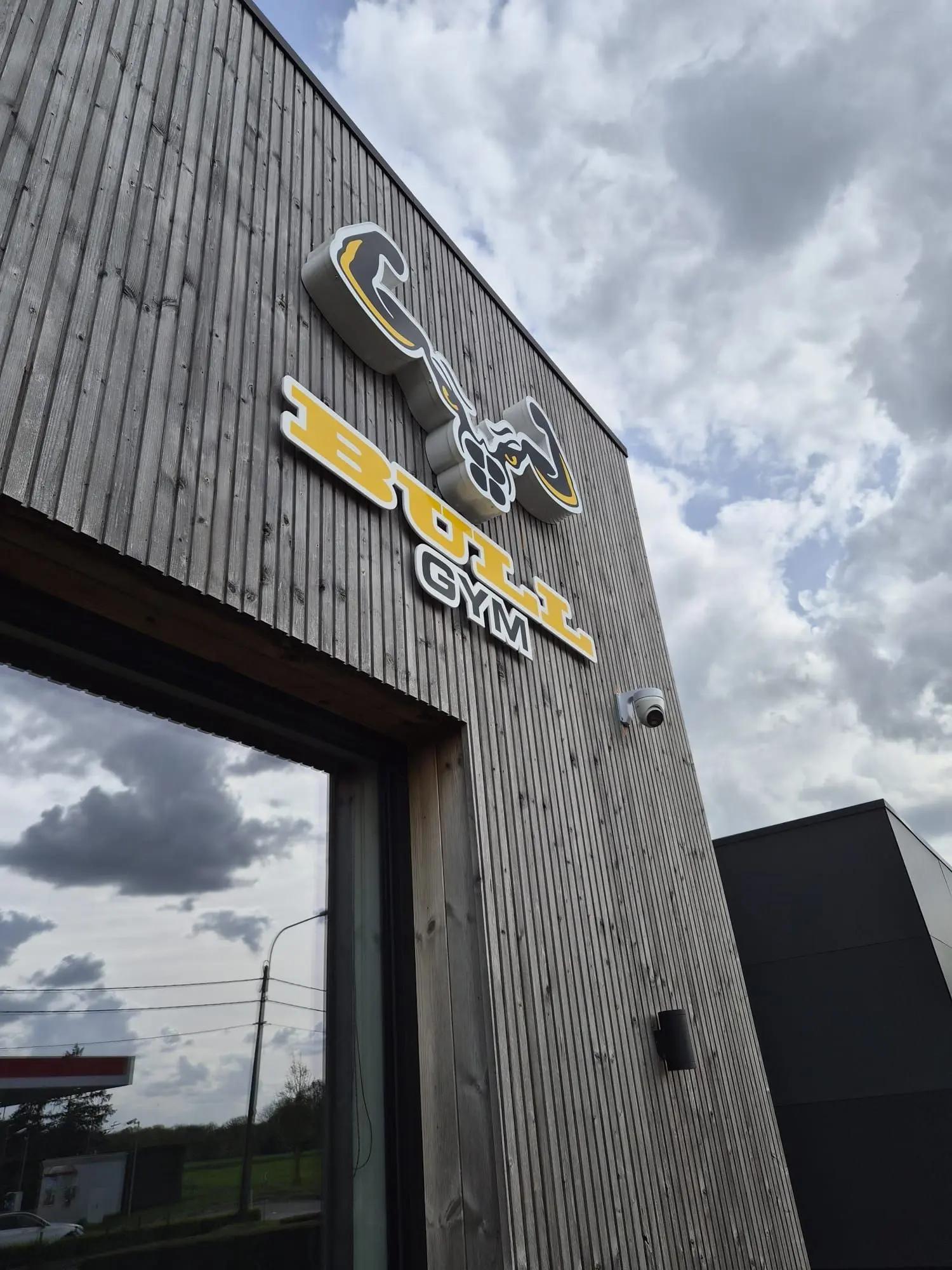 Angled view of the bull logo and lettering on the timber facade.
