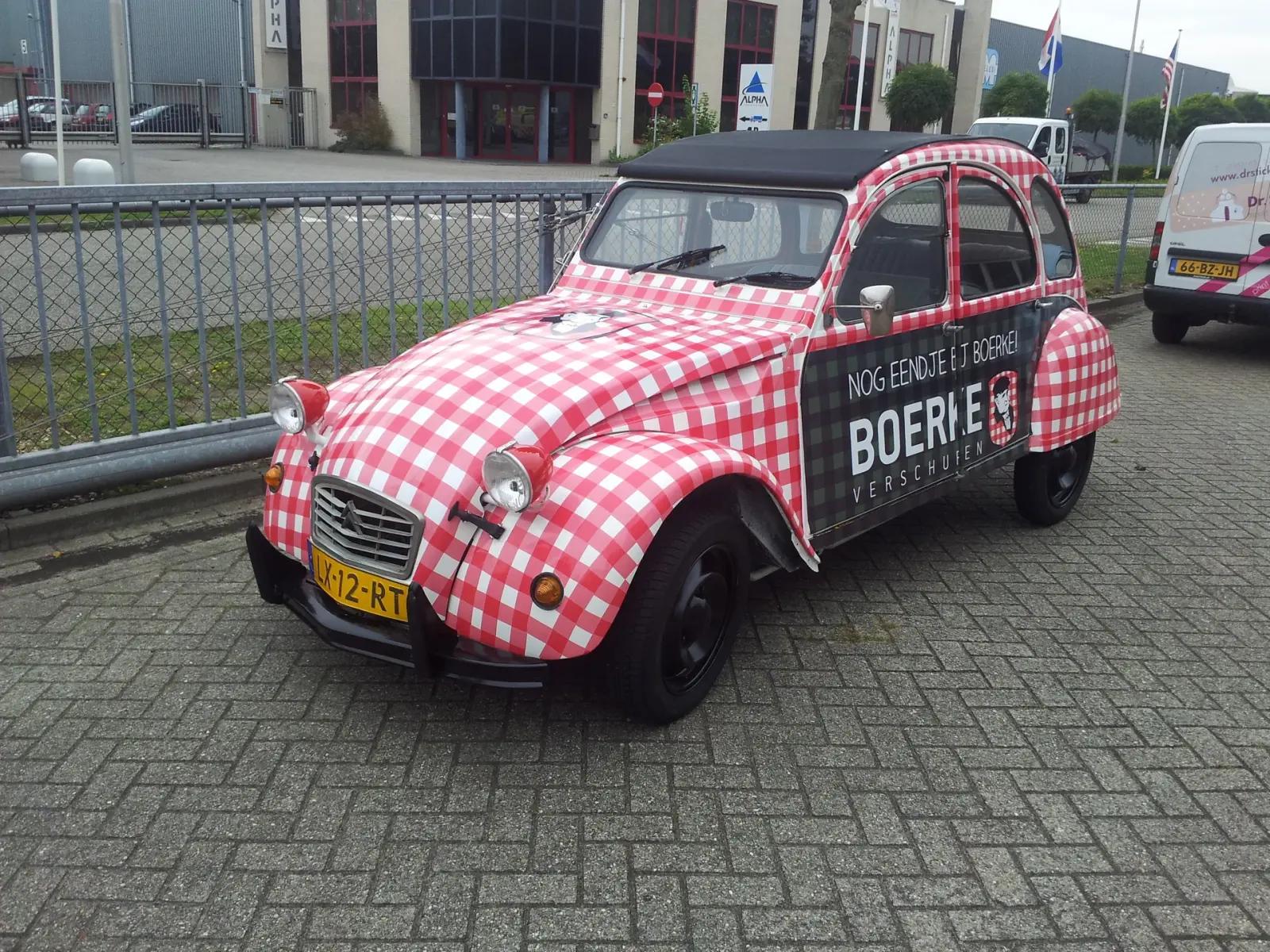 Citroën 2CV with red and white checks and Boerke Verschuren advertising graphics.