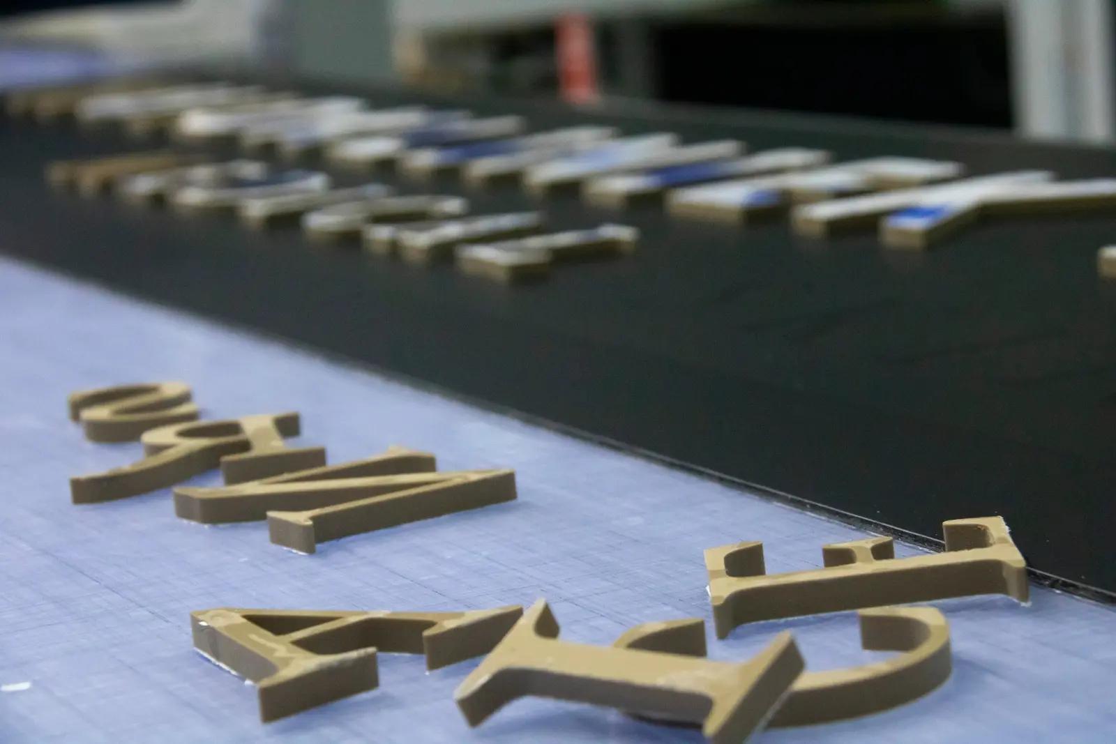 Routed acrylic letters on the black panel
