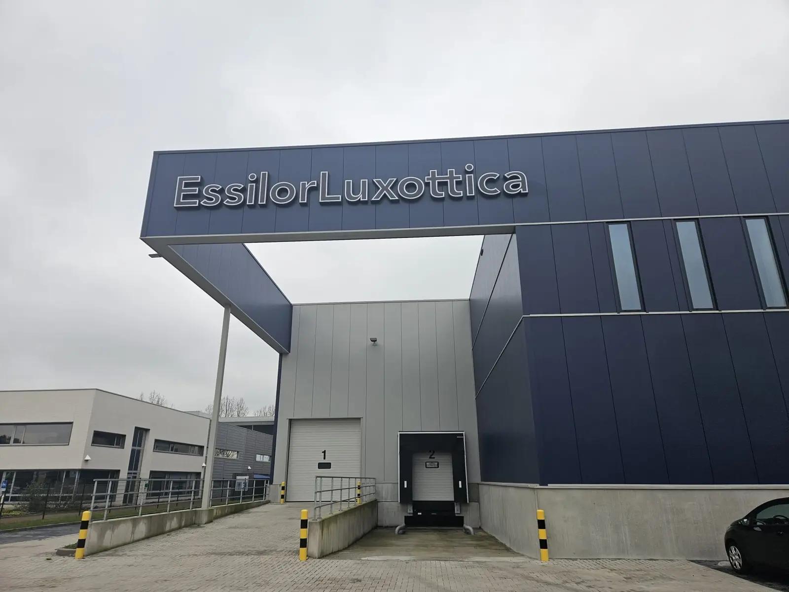 EssilorLuxottica fascia letters above the entrance in Wijchen, photographed in daylight.