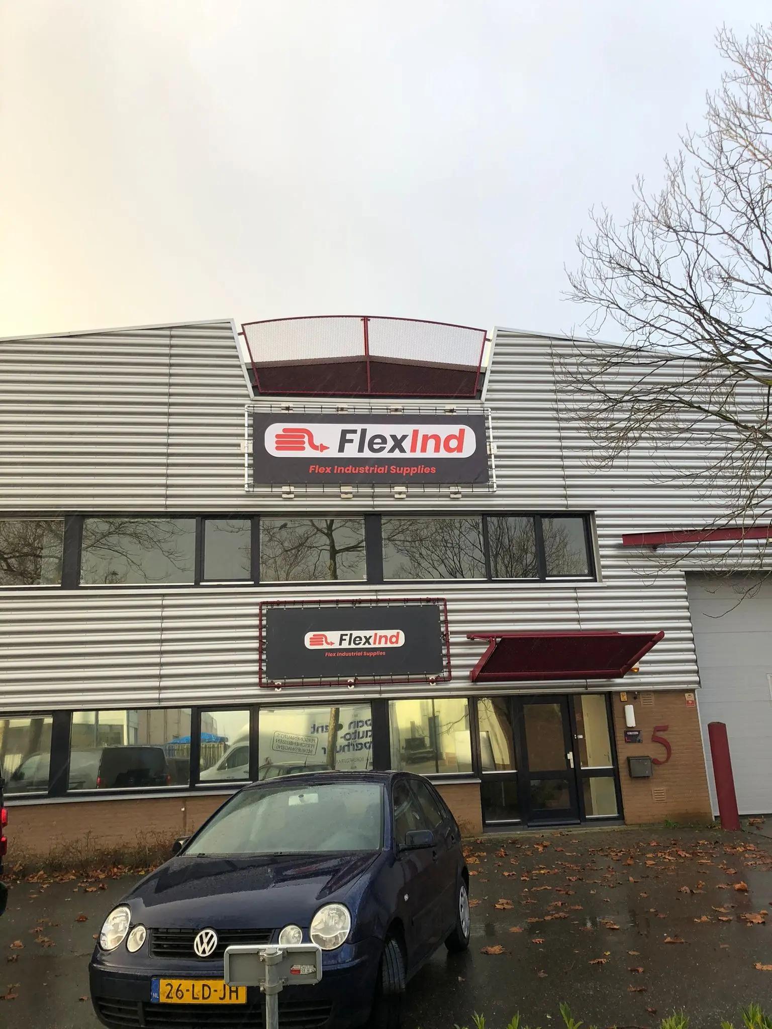 Business premises with a FlexInd sign on the upper facade.