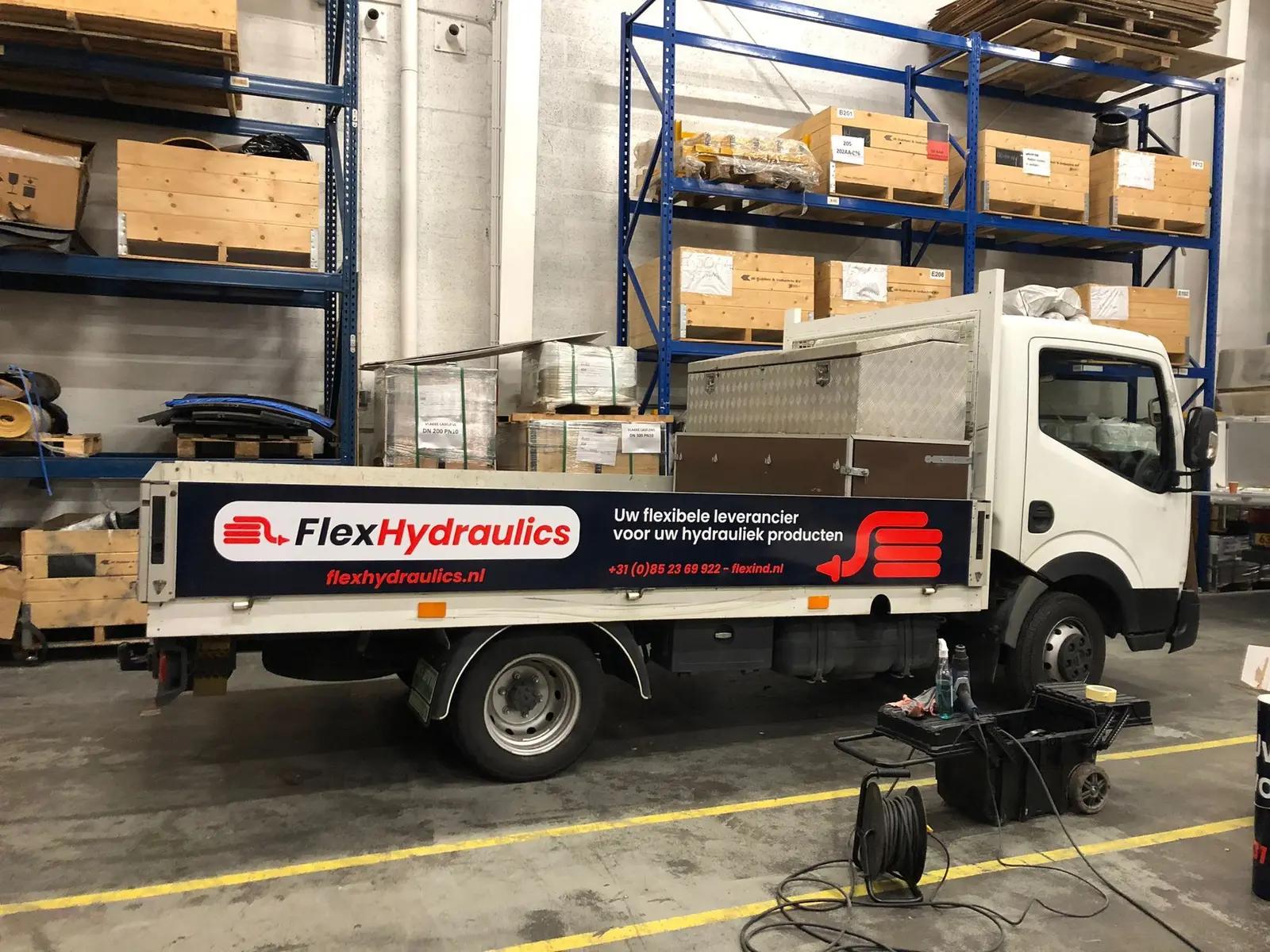 FlexHydraulics logo and product message on the side of the load bed.