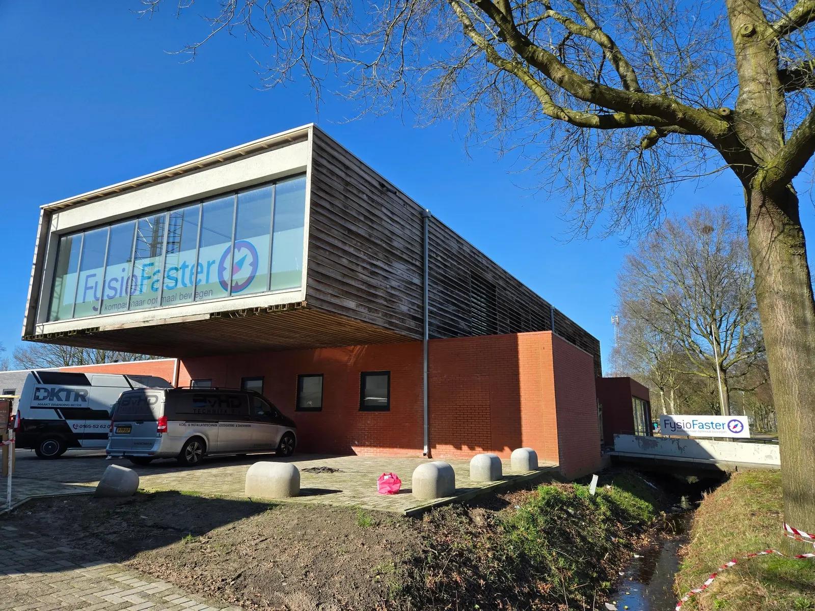 FysioFaster building on Sportlaan with a large glazed frontage, window lettering and signage at the entrance.