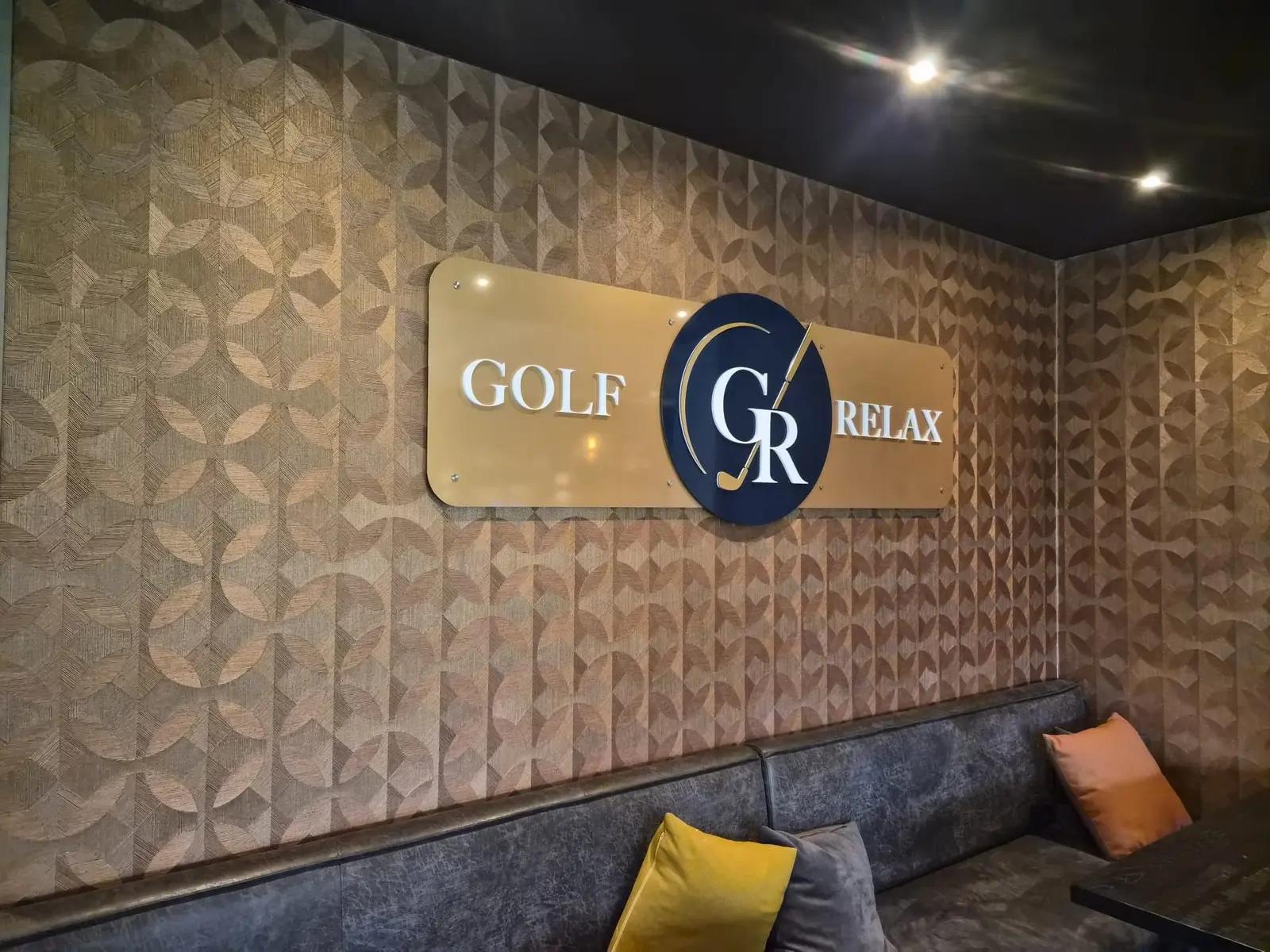 Golf & Relax interior logo on gold-coloured panels above a bench.