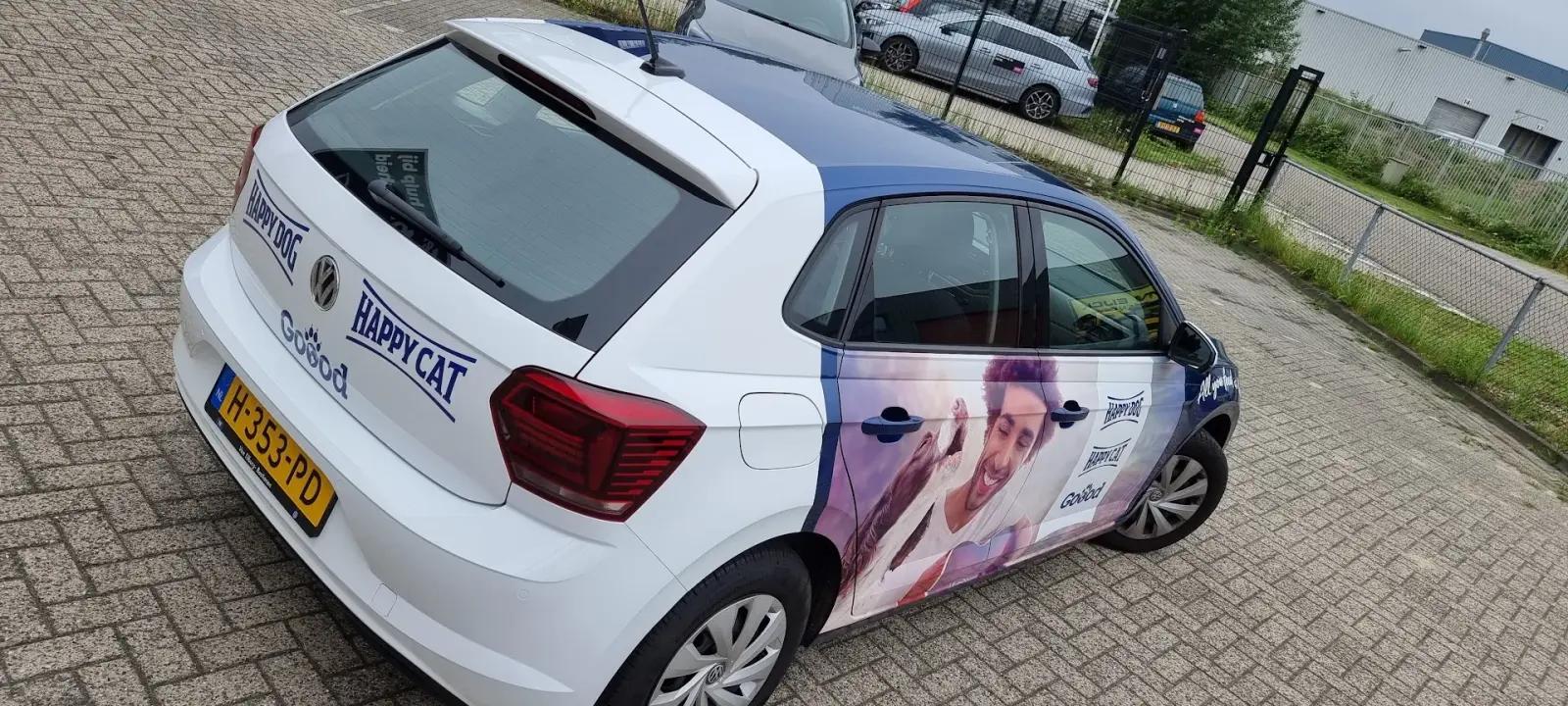 Volkswagen with a full-colour Happy Dog and Happy Cat advertising wrap.