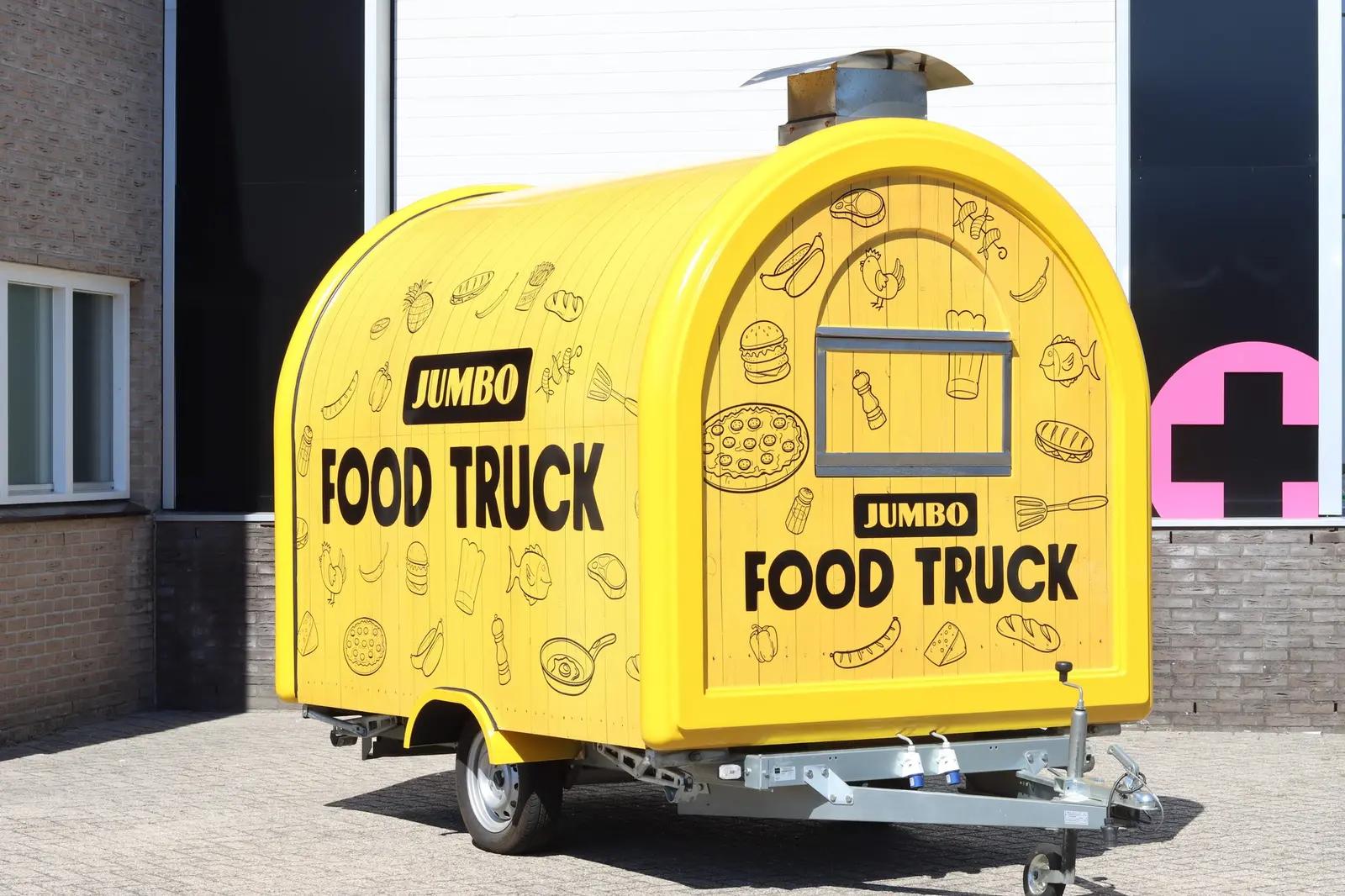 Closed catering trailer with graphics on the side and rear