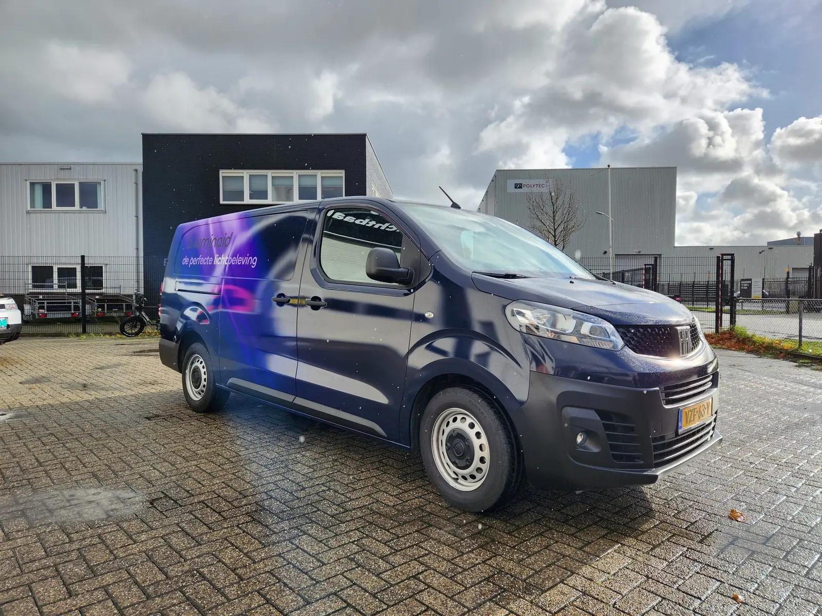 Purple and blue Luminaid wrap on a Fiat Scudo, viewed from the front corner.