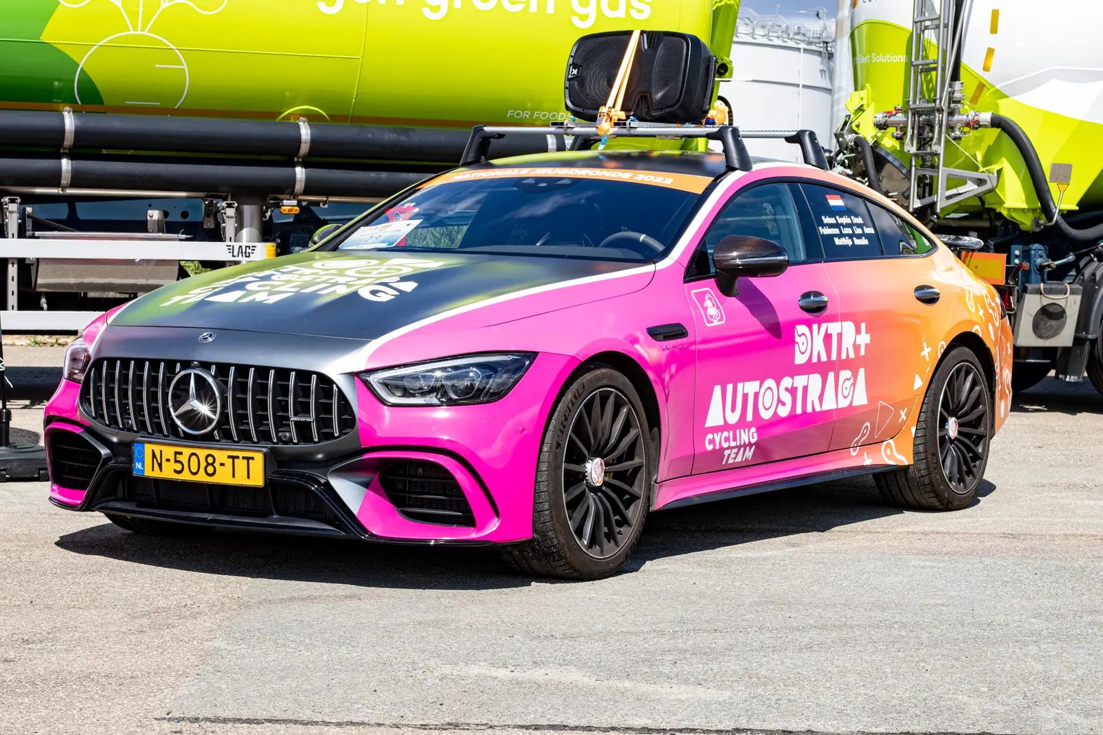 Pink and orange Mercedes with DKT+ AutoStrada Cycling Team advertising graphics at the 2022 Nationale Jeugdronde.