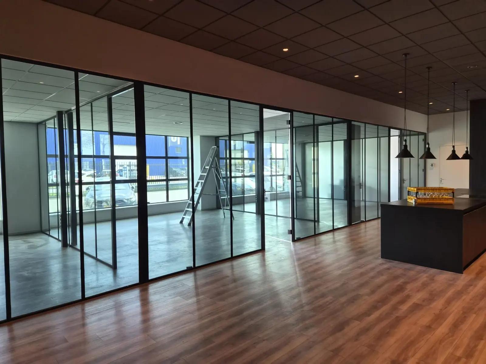 Glass office partitions with a darker transparent smoked-glass appearance