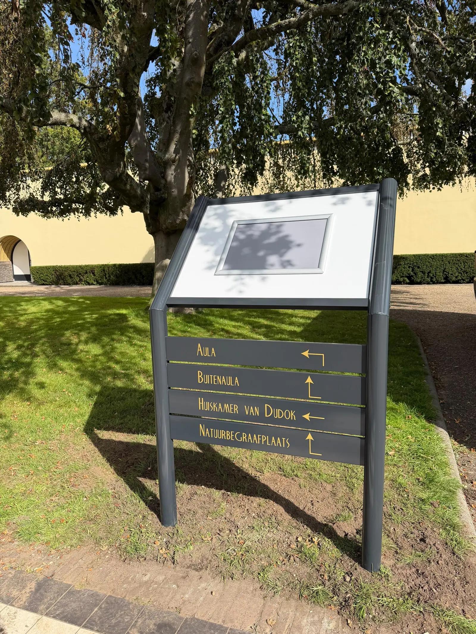 Information board with a site map and four directional panels, including Aula and Betula.