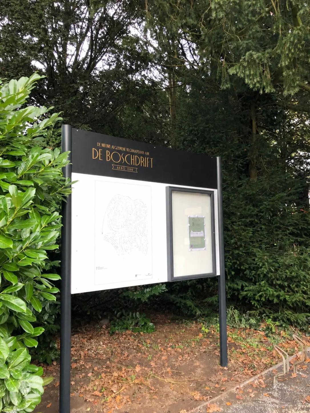 Information board at De Bosdrift cemetery in Hilversum, with a site map and notices.